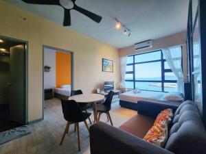 a living room with a couch and a table at Jesselton Quay Kota Kinabalu City Centre by LW Suites in Kota Kinabalu