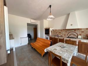 a kitchen with a table and a dining room at Villa Maccioni in Budoni