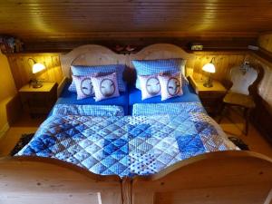 a bedroom with a large bed with blue at Ferienwohnungen Lärchennest zwischen Chiemsee und Bergen in Bernau am Chiemsee