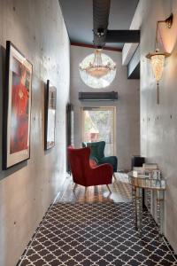 Ola Foundation Residence في ريغا: غرفة معيشة مع كرسي احمر وطاولة