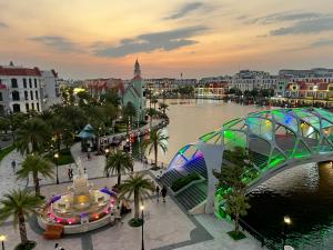 a view of a city with a bridge and a river at Legacy Hotel - Grand World Phú Quốc in Phú Quốc