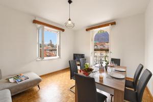 a living room with a table and chairs and a dining room at Castle View - Happy Rentals in Bellinzona