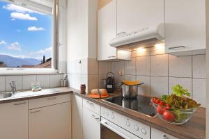 a kitchen with a bowl of vegetables on the counter at Castle View - Happy Rentals in Bellinzona