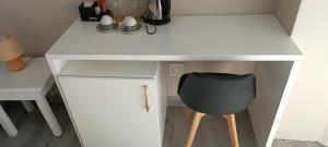 a white desk with a black chair underneath it at 40 on King BnB in East London