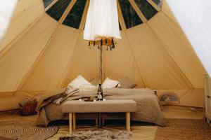 a bedroom with a bed in a tent at Glamping U Lesa in Rychnov nad Kněžnou
