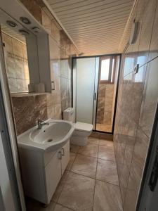a bathroom with a sink and a toilet at Erkal Pension in Antalya +186 photos