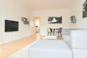 a living room with a white couch and a table at Fantastic 2-bed in Frederiksberg C in Copenhagen
