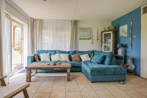 a living room with a blue couch and a coffee table at Appartement Regina - Residence Juliana Julianadorp aan Zee in Julianadorp +24 photos
