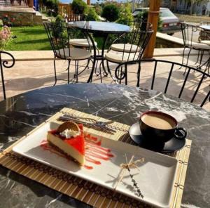 a piece of cake on a plate next to a cup of coffee at Limis Hotel in Çanakkale
