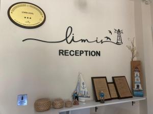 a shelf with a clock and a sign on a wall at Limis Hotel in Çanakkale