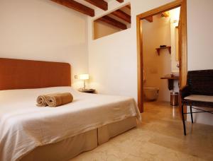 a bedroom with a bed with a towel on it at Agroturismo Ses Cases de Fetget in Son Servera