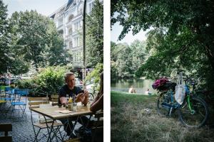 un hombre sentado en una mesa de picnic junto a un lago en STAYERY Berlin Friedrichshain, en Berlín