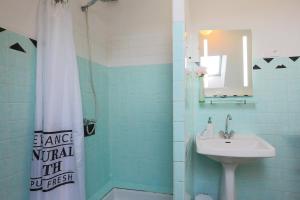 a bathroom with a sink and a shower with a mirror at Appartement centre Bretagne in Pabu +12 photos