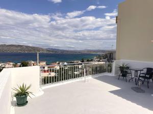 a balcony with a view of the water at Socratous House in Salamina