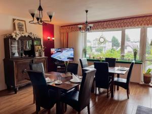 a dining room with a table and chairs at Villa Genevra in Koszalin