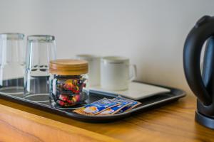 a tray with a jar of food on a table at Sunfun Beach House in Kannur
