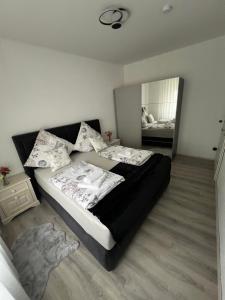 a bedroom with a large bed and a mirror at Apartment 1 in Duisburg-Mitte, Altstadt in Duisburg