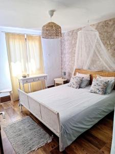 a bedroom with a white bed with a canopy at Cocorelax 2 Otro Lugar de Relax en Lanzarote in Guatiza