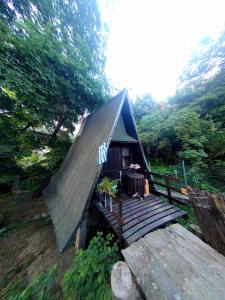 a small house with a wooden deck in a forest at Talos House in Rakhónion
