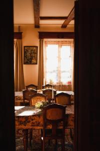 a dining room with a table and chairs and a window at Dwór Zaścianek in Sarnaki +31 photos