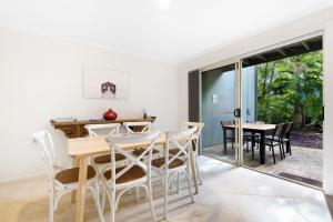 a dining room with a table and chairs at Cuttlefish Cove in Coffs Harbour