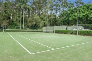 a tennis court with a net on top of it at Cuttlefish Cove in Coffs Harbour
