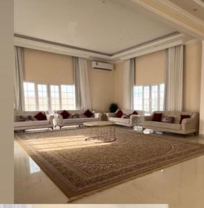 a large living room with couches and a rug at Alrabe3 شاليه 