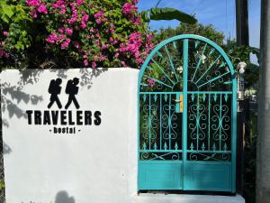 a gate with a sign that reads travelers niki at Hostel, Café & Garden Travelers in Santiago