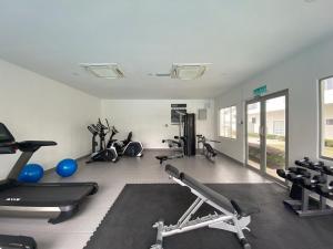 a gym with several treadmills and exercise machines at D'Camellia Ecohill Homestay in Semenyih