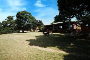 a large yard in front of a house at Dwarka Lawns Cottages in Mahabaleshwar