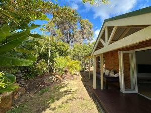 a house with a porch with a couch on the side at Three bears beach house in Dunsborough