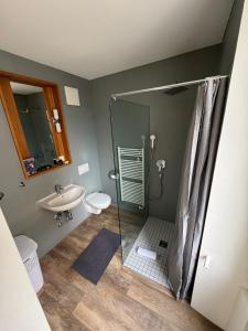 a bathroom with a shower and a sink at Smart Living Swiss in Chiasso