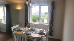 a dining room with a table and a window at Top Location Perranporth Apartment in Perranporth