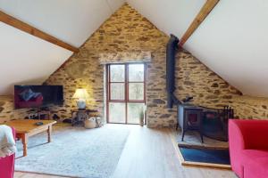 a living room with a stone wall at West Hollowcombe Farm Cottages - full site in Dulverton