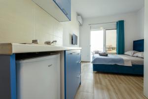 a bathroom with a sink and a bedroom with a bed at DERON Apartments in Ulcinj