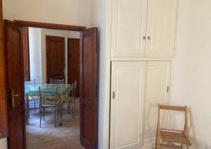 a dining room with a table and a table and chairs at Casa Per 4 in Porto Santo Stefano +4 photos
