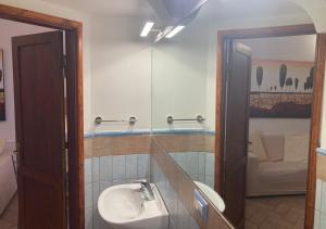 a bathroom with a sink and a mirror at Casa Per 4 in Porto Santo Stefano