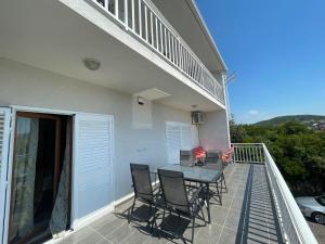 a balcony of a house with a table and chairs at Fany in Neum