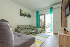 a living room with a couch and a table at DERON Apartments in Ulcinj