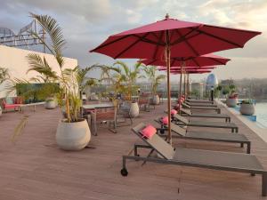 a row of lounge chairs and umbrellas on a roof at Skynest Residences by Lisa's Paradise E in Nairobi