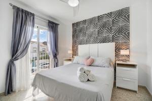 a bedroom with a bed with two pairs of shoes on it at Casa Blanca in Rota