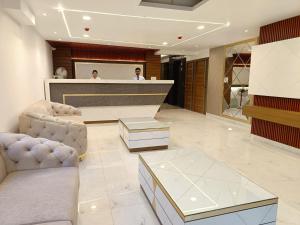 two people in the lobby of a hotel at Hotel Aman Residency in Allahābād