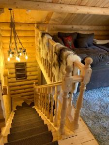a staircase in a log cabin with a bed at Hahnenkleer Hütte in Goslar