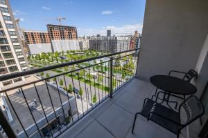 a balcony with a table and chairs and a view of a city at Belgrade Waterfront Residences - Beograd na vodi in Belgrade