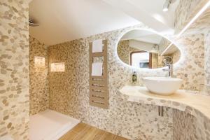 a bathroom with a sink and a mirror at Welcome Hotel in Villefranche-sur-Mer