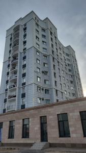 a large tall building with windows on top of a building at Comfort Turkestan in Türkistan