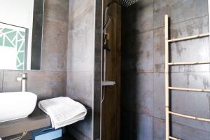 ein Bad mit einem Waschbecken und einer Dusche in der Unterkunft Superbe maison de vacances entre plage et marais - 7 pers in Brem Sur Mer