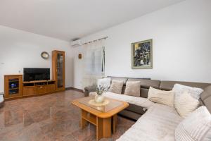 a living room with a couch and a coffee table at Villa Laura in Vantačići