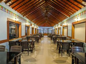 a row of tables and chairs in a restaurant at Desert King Resort in Dhordo +51 photos