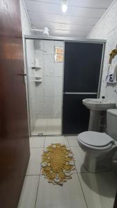 a bathroom with a shower and a toilet and a sink at Casa no centro de Areia in Areia